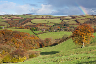 Autumnal colours on Exmoor with rainbow in the sky