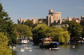 View of Windsor Castle from across the River Thames. Pleasure boats in the foreground