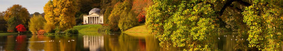 View across the lake at Stourhead, to the Temple of Apollo and autumn colours